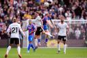 Liverpool's Alexis Mac Allister and Crystal Palace's Adam Wharton (right) battle for the ball in the air during the Premier League match at Selhurst Park, London. Picture date: Saturday October 5, 2024.