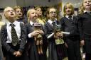 The choir at Stanwix School with Caritas dolls Carrie and Taz who represented children in need of adoption