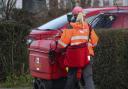 Royal Mail delivering mail (PA)