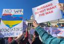 People holding signs 'RUSSIANS DO NOT WANT THE WAR' take part in a demonstration in Trafalgar Square, London, on February 27, 2022. Photos via PA.