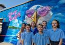 Children with the new Tech Moon mural at Stourfield Infant and Junior Schools.