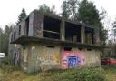 The control tower is derelict and covered in graffiti, including an image of Winston Churchill