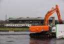 Contractors with excavators have begun clearing the concrete seating terraces at GAA stadium in Belfast (PA)