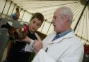 Fordingbridge Show at Godshill - Poultry judge Rodney Wood takes a look at a Belgian barbud-anvers hen with visitor Max Burns.