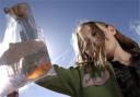 A child with her goldfish at a fair