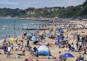 People enjoying the sunny weather on Bournemouth beach