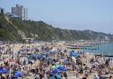 People enjoying sunny weather on Bournemouth beach