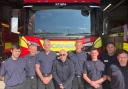 Neil Duncan-Jordan (centre) with firefighters in Poole