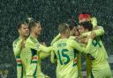 Kieffer Moore (headband) celebrates with his Wales team-mates after opening the scoring against Montenegro (Risto Bozovic/AP)