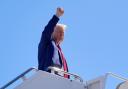 Republican presidential nominee former president Donald Trump gestures as he boards a plane on Saturday in Las Vegas (Alex Brandon/AP)