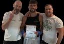 Sam Carr receiving his certificate of Home Counties Championship with boxing coaches Jason Barker on the left and Head Coach Joe Hayes on the right.