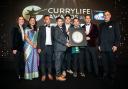 The restaurant team receiving the award from Lord Karan Bilimoria, founder of Cobra Beer, Rushanara Ali MP and awards host Camilla Tominey