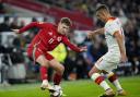 Wales' David Brooks (left) and Montenegro's Nikola Krstovic (right) battle for the ball during the