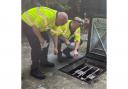 Environment officers inspecting the wet well at a pumping station to make sure all pumps, chains and floats are in good working order