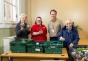 Residents Carol Brown and Ben Crofton with Canford Chase companionship team Leader Vicky Day and food bank project manager Ian Stoney