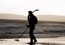 A metal detectorist on Bournemouth beach