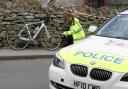 PROBE: Police examine the bike at the scene of the crash