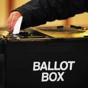 File photo dated 06/05/10 of a voter placing a ballot paper in the ballot box. More than half of people say climate change will influence the way they vote in the next general election, a survey suggests..