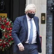 Boris Johnson outside a festive Downing Street. Credit: PA