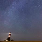 A meteor during the Perseid meteor shower seen over Happisburgh lighthouse, Norfolk. Sky gazers are set to be treated to a light display next week as Earth passes through debris left behind by a comet. Issue date: Friday August 6, 2021. Credit: PA