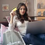 A woman shopping online on her laptop. Credit: Canva