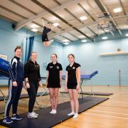 PE teacher Laura Greening, Head of PE Charlotte Warren and students at Parkstone Grammar School with their new trampoline and end deck