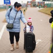 A family crossing the border point from Ukraine into Medyka, Poland. Photo via PA/Victoria Jones.