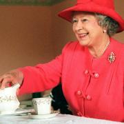 The Queen joined Mrs Susan McCarron for tea in her home in the Castlemilk area of Glasgow in 1999. Picture: PA