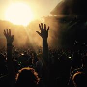 People cheering in the crowd at a festival. Credit: Canva