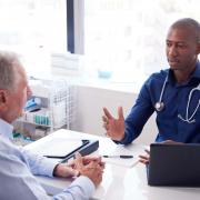 A doctor speaking with a patient. Credit: Canva