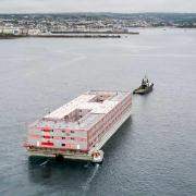 The Bibby Stockholm barge arriving in Falmouth in May