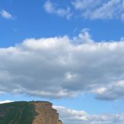 Beachgoers at West Bay on Sunday evening - two hours later the cliff collapsed