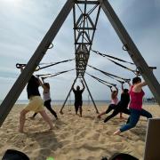 Kevin Hubble, owner of Three Sixty Fitness, leading a class on his exercise frame.