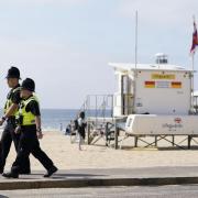 File image of police officers walking along a stretch of Bournemouth sea front