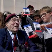 D-Day veteran Bill Gladden, 6th Airborne Army Recce Regiment RAC meets local French schoolchildren at the British Normandy Memorial at Ver-sur-Mer in France ahead of the 79th anniversary of the D-Day landings. Picture date: Monday June 5, 2023.