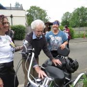 Fernhill resident Nigel Gullis has a hands-on look at a bike with, from left: Companionship Team Leader Cara Duroe, Nurse Agi Ciok and Home Manager Francis Bosompim.