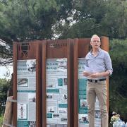 Vice chairman of FCRA, Paul De Jonghe. in front of one of the totem boards.