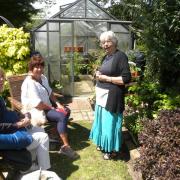 Christine Oliver talks to two visitors at her garden which was one of those open.