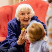 Brook View resident Diana Pearce with a young visitor