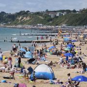 People enjoying the sunny weather on Bournemouth beach