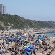 People enjoying sunny weather on Bournemouth beach