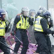 Fire extinguishers are used on police officers as trouble flares during an anti-immigration protest outside the Holiday Inn Express in Rotherham (Danny Lawson/PA)