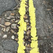 Double yellow lines were painted through potholes in Avenue Road, Lymington