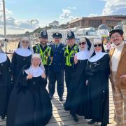 The cast joined officers in spreading safety messages on the beach.