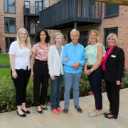 The McCarthy Stone team join reservists Mr and Mrs Mason on the Village Green at Wimborne's newest retirement community