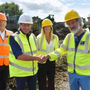 Eco's Peter Hardy (second left) shakes hands with Cllr Andy Hadley (second right) watched by BCP Council's David Rickards, Kate Langdown and Eco MD Justin Dampney. Picture: Andy Diprose.