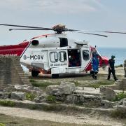 A coastguard helicopter, the ambulance service, a hazard alert response team and Dorset and Wiltshire Fire Service responded to the incident.