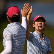 United States’ Rose Zhang, right, is congratulated by Andrea Lee after hitting out of a bunker and into the cup on the 13th (Matt York/AP)