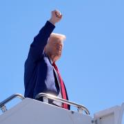 Republican presidential nominee former president Donald Trump gestures as he boards a plane on Saturday in Las Vegas (Alex Brandon/AP)