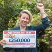 Amy with her cheque from Postcode Lottery.